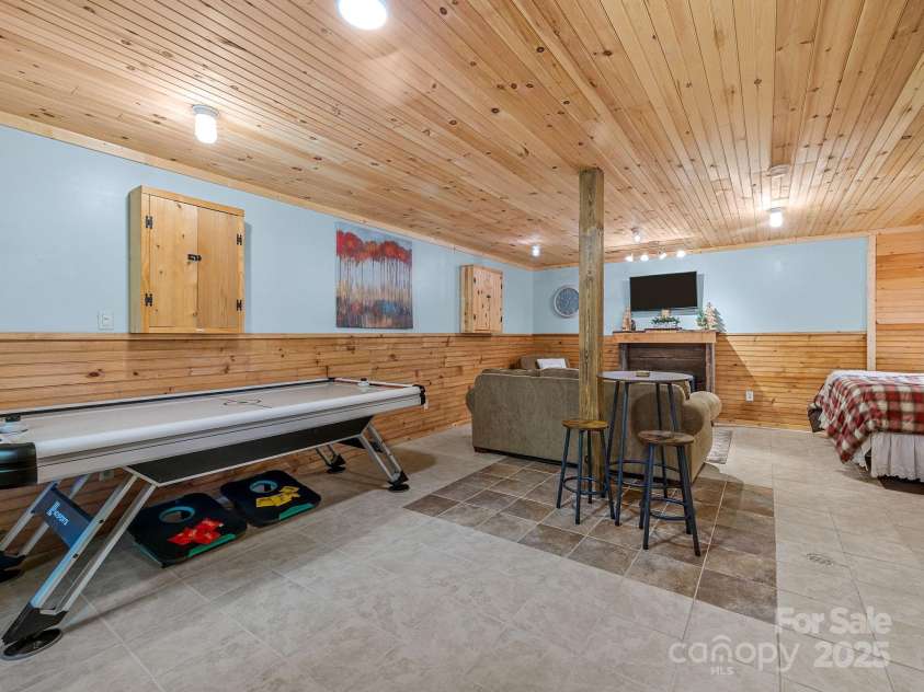 18 Lennox Road, Landrum, SC 29356.  MLS# CAR4253831, YatesRealty ID 17646. Basement recreation area with sleeping space.