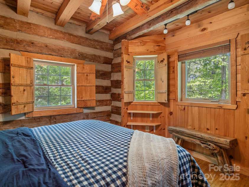 18 Lennox Road, Landrum, SC 29356.  MLS# CAR4253831, YatesRealty ID 17646. Primary bedroom with lots of windows.