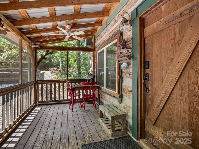 18 Lennox Road, Landrum, SC 29356.  MLS# CAR4253831, YatesRealty ID 17646. Screened porch with ceiling fans and plenty of space to socialize.