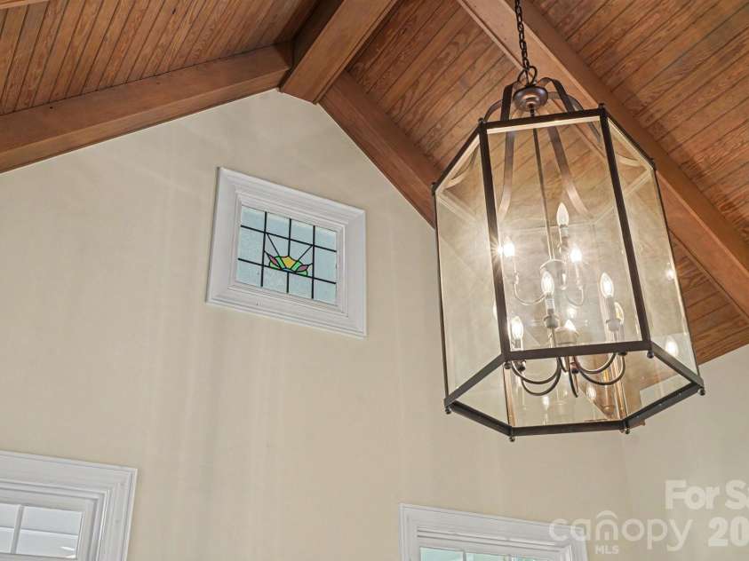 7609 Windaliere Drive, Cornelius, NC 28031.  MLS# CAR4358973, YatesRealty ID 17651. Small antique Window with vaulted ceilings