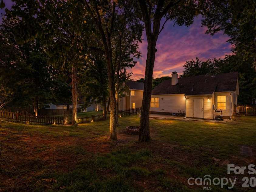 7442 Crestside Lane, Charlotte, NC 28227.  MLS# CAR4373229, YatesRealty ID 17666. Twilight (Ai) backyard