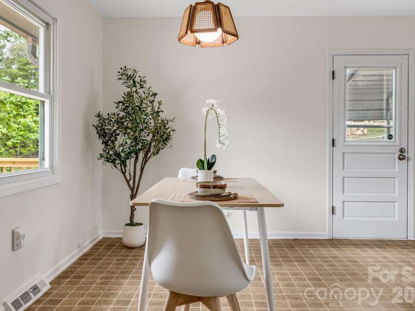 18 Compton Drive, Asheville, NC 28806.  MLS# CAR4343656, YatesRealty ID 17688. Dining area with side door to back deck