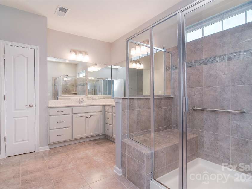 3073 Oliver Stanley Trail, Lancaster, SC 29720.  MLS# CAR4253520, YatesRealty ID 17689. Glass enclosure, built in bench seating and tiled shower.