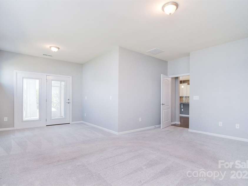 3073 Oliver Stanley Trail, Lancaster, SC 29720.  MLS# CAR4253520, YatesRealty ID 17689. Luxurious primary en- suite w/seating space on the main level and connecting to screened in porch