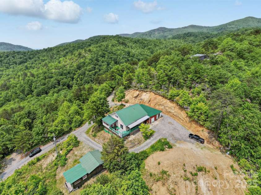 33 Faholoa Ridge Road, Black Mountain, NC 28711.  MLS# CAR4263286, YatesRealty ID 17690. Front of home, aerial, private with views all around