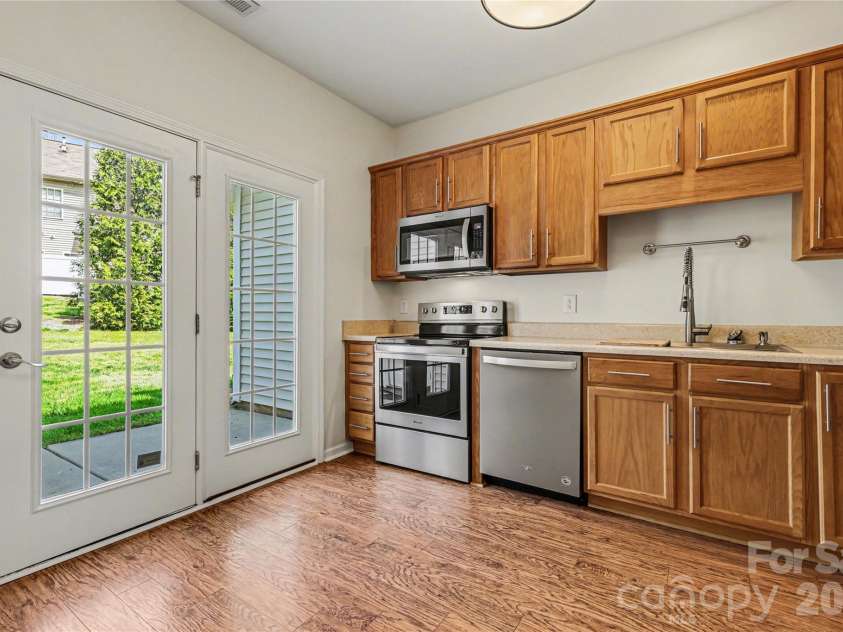 152 Charterhouse Lane, Fort Mill, SC 29715.  MLS# CAR4419693, YatesRealty ID 17696. Direct access to the back patio from the light-filled kitchen