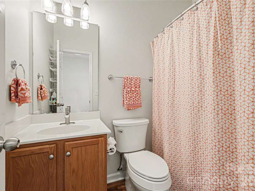 152 Charterhouse Lane, Fort Mill, SC 29715.  MLS# CAR4419693, YatesRealty ID 17696. Ensuite bath features a tub/shower combo, updated lighting and vanity with storage