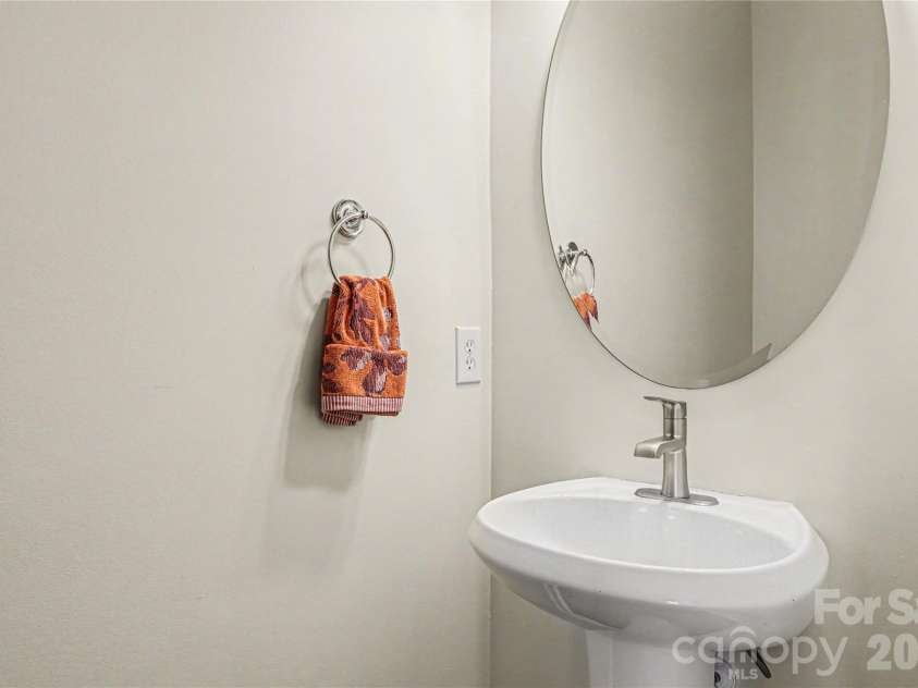 152 Charterhouse Lane, Fort Mill, SC 29715.  MLS# CAR4419693, YatesRealty ID 17696. Half bath for guests on the main floor features a pedestal sink