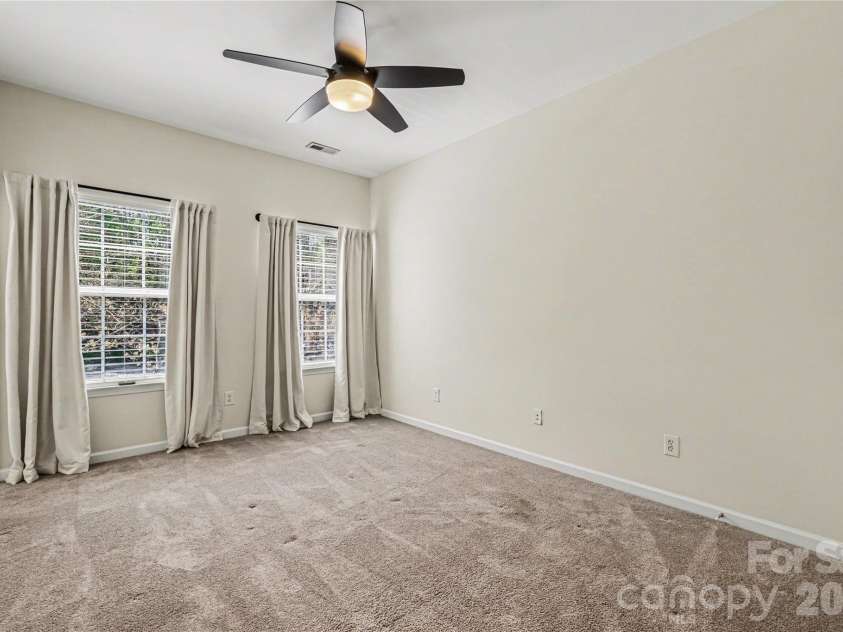152 Charterhouse Lane, Fort Mill, SC 29715.  MLS# CAR4419693, YatesRealty ID 17696. Spacious primary suite overlooks the back yard