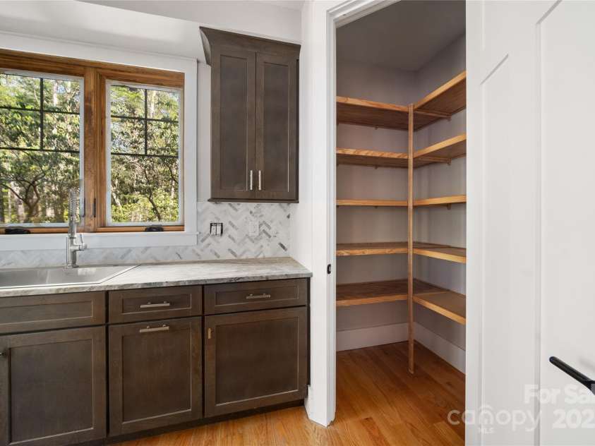 29 Wild Deer Trail, Zirconia, NC 28790.  MLS# CAR4243690, YatesRealty ID 17702. Walk in pantry with wooden shelving