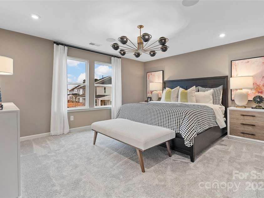 7101 Short Stirrup Lane, Mint Hill, NC 28227.  MLS# CAR4264118, YatesRealty ID 17710. 9' Ceilings and bright windows make this primary bedroom look and feel grand. *actual finishes, structural selections, and orientation may vary.