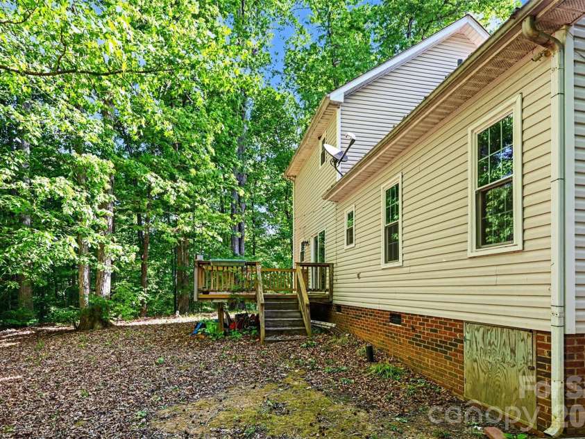 4718 Titus Court, Monroe, NC 28110.  MLS# CAR4373667, YatesRealty ID 17713. Wooded backyard