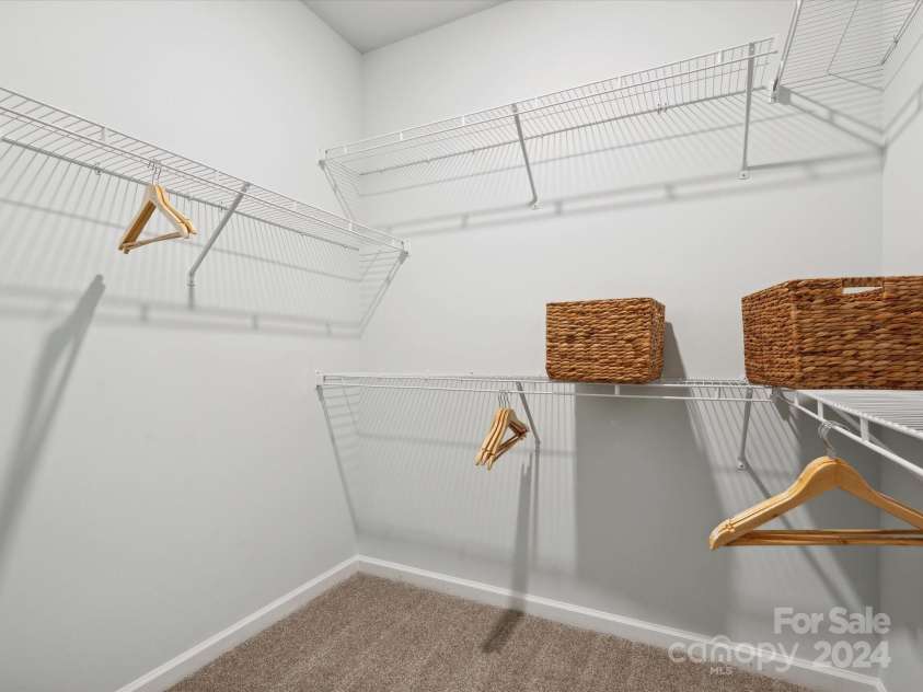 1053 Bull Dog Lane, Wingate, NC 28174.  MLS# CAR4192555, YatesRealty ID 17718. Representational photo of Model Owners walk in closet