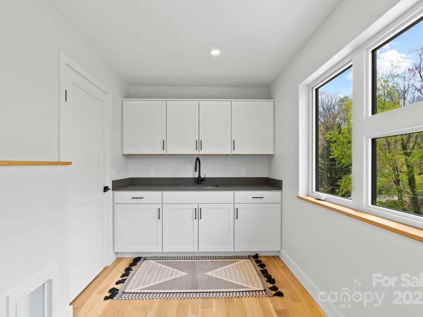 520 Tenth Street, Black Mountain, NC 28711.  MLS# CAR4247176, YatesRealty ID 17733. Laundry Room has Storage, Sink, and a View