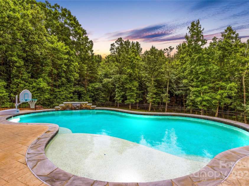 127 Tradition Lane, Mooresville, NC 28115.  MLS# CAR4165702, YatesRealty ID 17737. Pool with waterfall