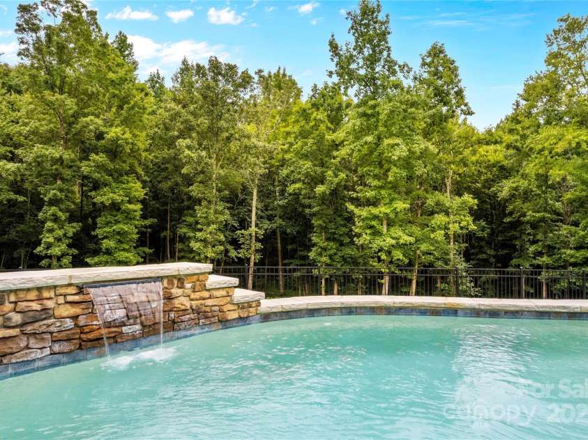 127 Tradition Lane, Mooresville, NC 28115.  MLS# CAR4165702, YatesRealty ID 17737. Pool with waterfall