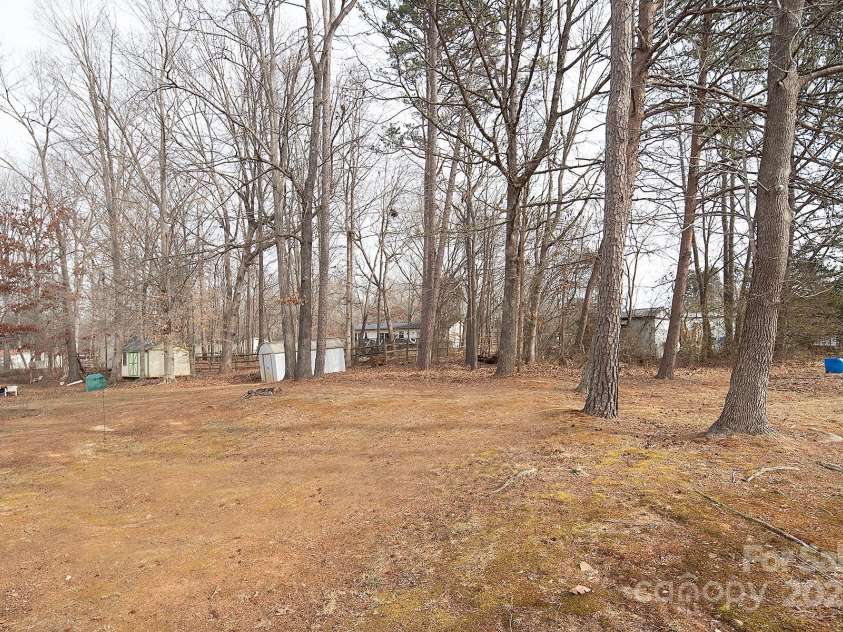 115 Tradewinds Court, Mooresville, NC 28115.  MLS# CAR4215397, YatesRealty ID 1774. Rear view of backyard- property is over 1/2 an acre.