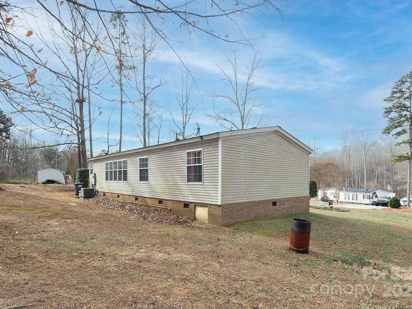 115 Tradewinds Court, Mooresville, NC 28115.  MLS# CAR4215397, YatesRealty ID 1774. Rear view of spacious backyard.