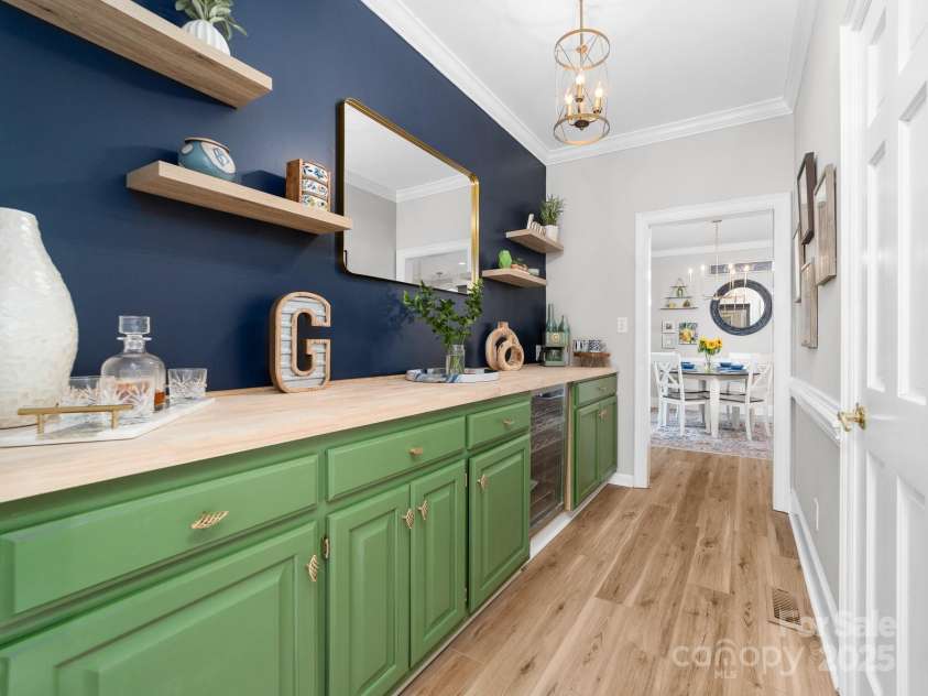 1115 Maremont Court, Matthews, NC 28104.  MLS# CAR4265008, YatesRealty ID 17750. Butler's Pantry connects the kitchen/breakfast area to the den.  Newly renovated butler's pantry has butcher block countertops, beverage fridge and additional pantry