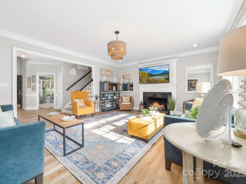 1115 Maremont Court, Matthews, NC 28104.  MLS# CAR4265008, YatesRealty ID 17750. Exceptionally large den with gas log fireplace and freshly installed LVP.  Den is spacious enough to accommodate several pieces of large furniture and a sectional couch.