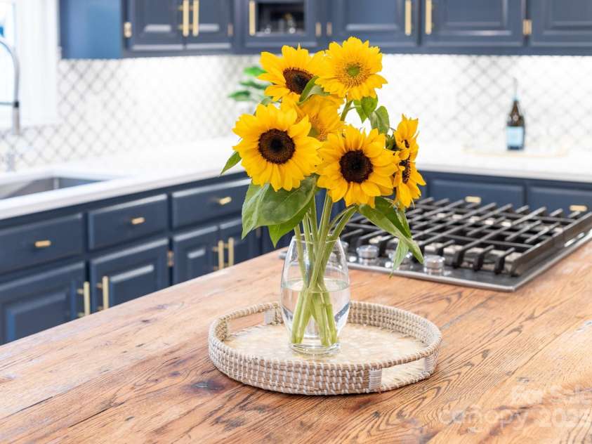 1115 Maremont Court, Matthews, NC 28104.  MLS# CAR4265008, YatesRealty ID 17750. Kitchen island with butcher block counter and gas cooktop.