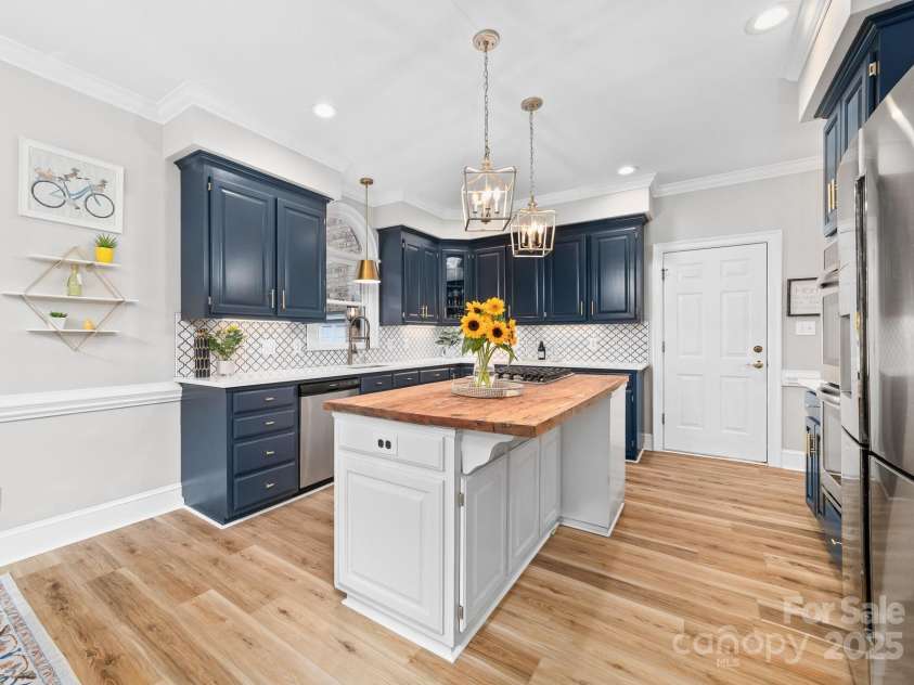 1115 Maremont Court, Matthews, NC 28104.  MLS# CAR4265008, YatesRealty ID 17750. Kitchen with newly installed LVP flooring and hardwood floors remain beneath the LVP.
