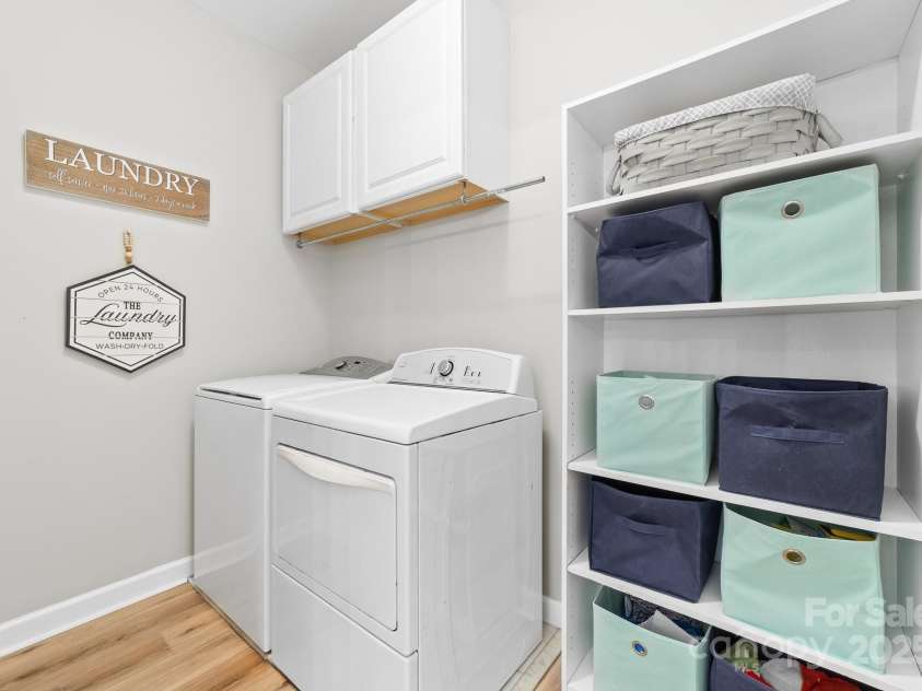 1115 Maremont Court, Matthews, NC 28104.  MLS# CAR4265008, YatesRealty ID 17750. Laundry room on main level with cabinets and newly installed LVP flooring.
