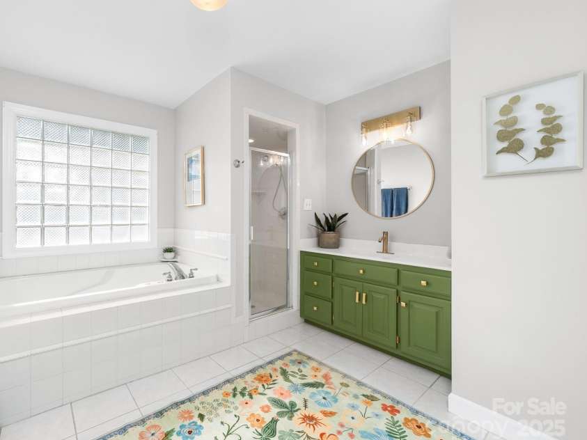 1115 Maremont Court, Matthews, NC 28104.  MLS# CAR4265008, YatesRealty ID 17750. Primary bathroom with huge soaking tub and walk in shower.