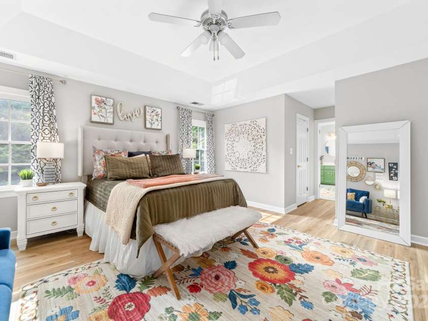 1115 Maremont Court, Matthews, NC 28104.  MLS# CAR4265008, YatesRealty ID 17750. Primary bedroom with tray ceiling, LVP flooring and en suite bathroom