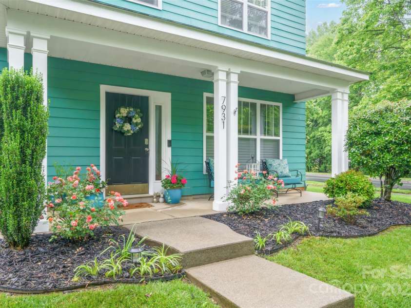 7931 Baylis Drive, Huntersville, NC 28078.  MLS# CAR4265506, YatesRealty ID 17760. Covered front porch with a view of the woods