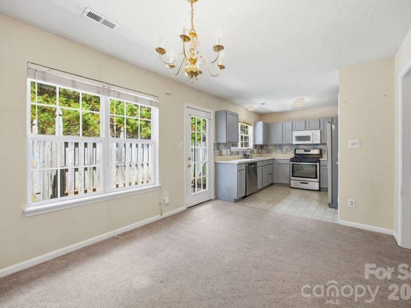 8616 Mineral Ridge Way, Charlotte, NC 28269.  MLS# CAR4377358, YatesRealty ID 17788. Dining room and Kitchen
