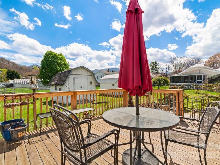 641 Camelot Drive, Waynesville, NC 28786.  MLS# CAR4244249, YatesRealty ID 17801. Lovely back porch with fenced backyard and 2 sheds