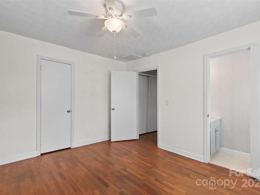 641 Camelot Drive, Waynesville, NC 28786.  MLS# CAR4244249, YatesRealty ID 17801. Primary bedroom with en-suite half bath