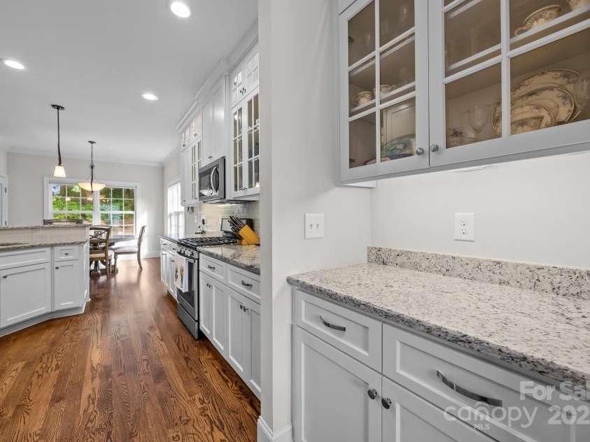 4004 Saint Andrews Court, Cramerton, NC 28032.  MLS# CAR4265985, YatesRealty ID 17805. Butler's Pantry with lighted upper cabinets