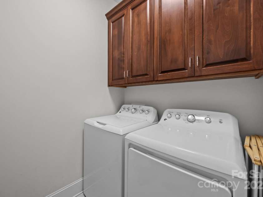 4004 Saint Andrews Court, Cramerton, NC 28032.  MLS# CAR4265985, YatesRealty ID 17805. Laundry Room with tile flooring & upper cabinet storage