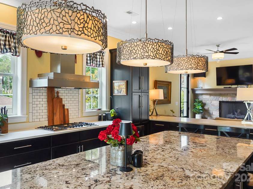 2354 Valelake Road, York, SC 29745.  MLS# CAR4266023, YatesRealty ID 17806. Stunning kitchen with a large eat-in island overlooking a keeping room with a fireplace.