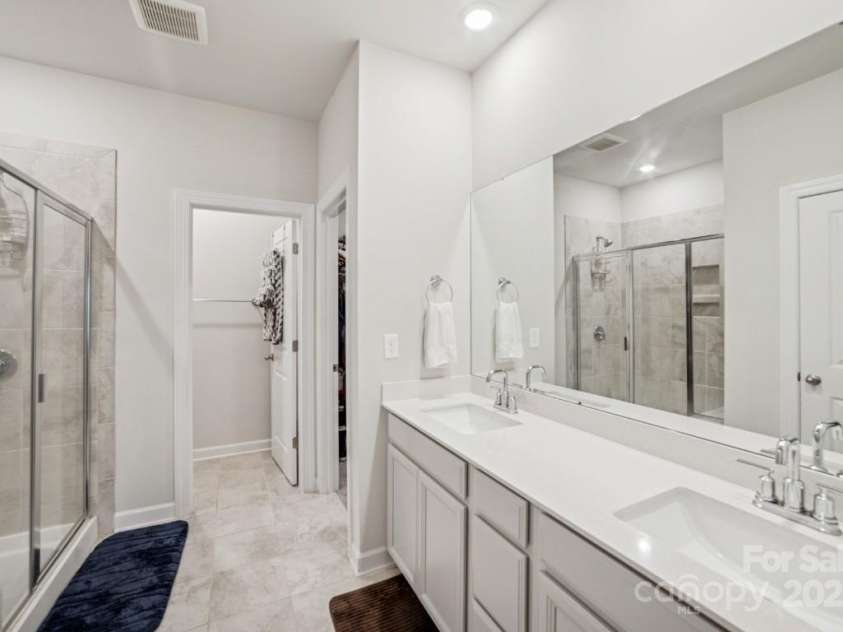 9525 Festival Way, Charlotte, NC 28215.  MLS# CAR4263190, YatesRealty ID 17807. Primary bath with dual sinks, shower, private water closet, and linen closet.