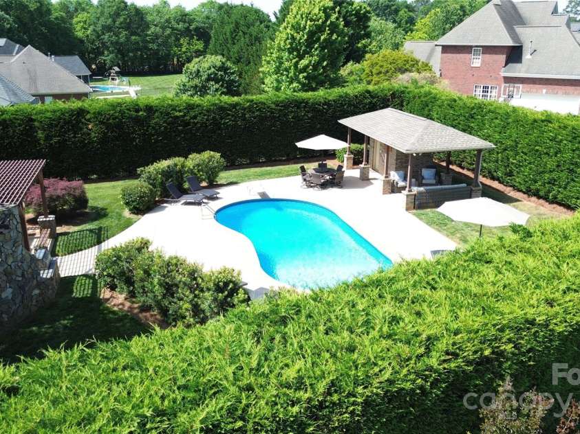 3000 J R Court, Stanley, NC 28164.  MLS# CAR4254396, YatesRealty ID 17811. Backyard private oasis.