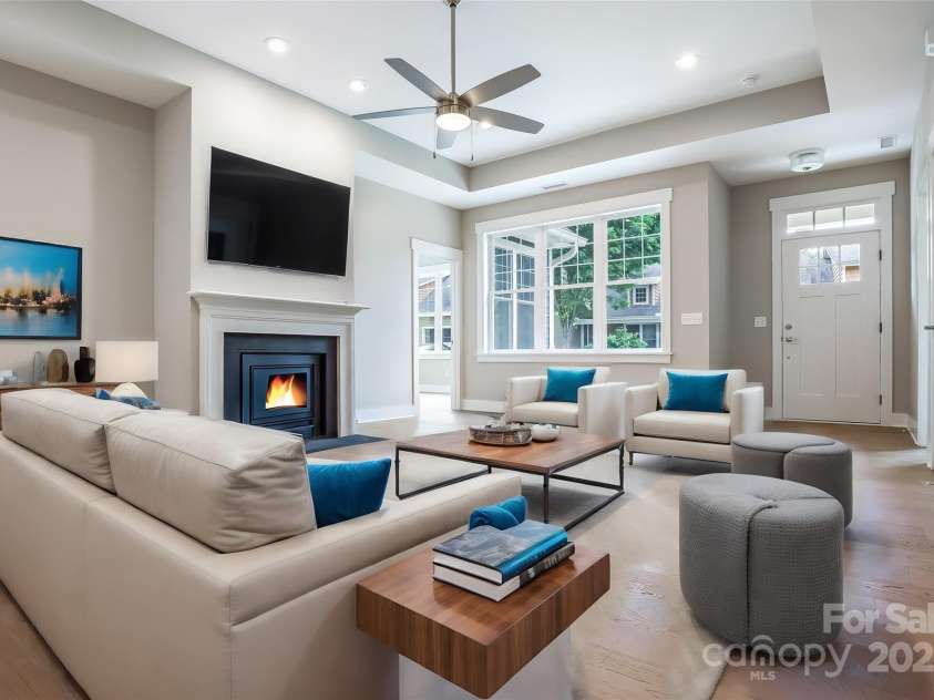 48 Creekside View Drive, Asheville, NC 28804.  MLS# CAR4046496, YatesRealty ID 17815. Virtually staged living room with high trey ceilings and a vented gas fireplace.