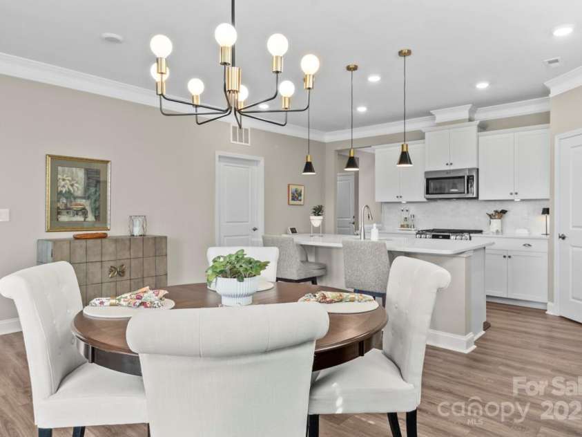 329 Secretariat Drive, Iron Station, NC 28080.  MLS# CAR4253728, YatesRealty ID 17822. A stunning upgraded light fixture accents the dining area