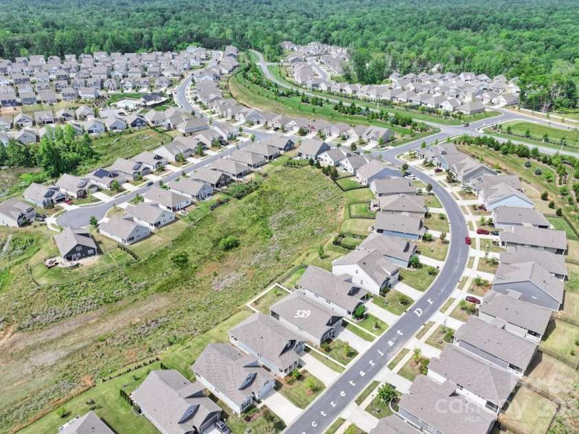 329 Secretariat Drive, Iron Station, NC 28080.  MLS# CAR4253728, YatesRealty ID 17822. Aerial view of the home situated on the lot and view of common area