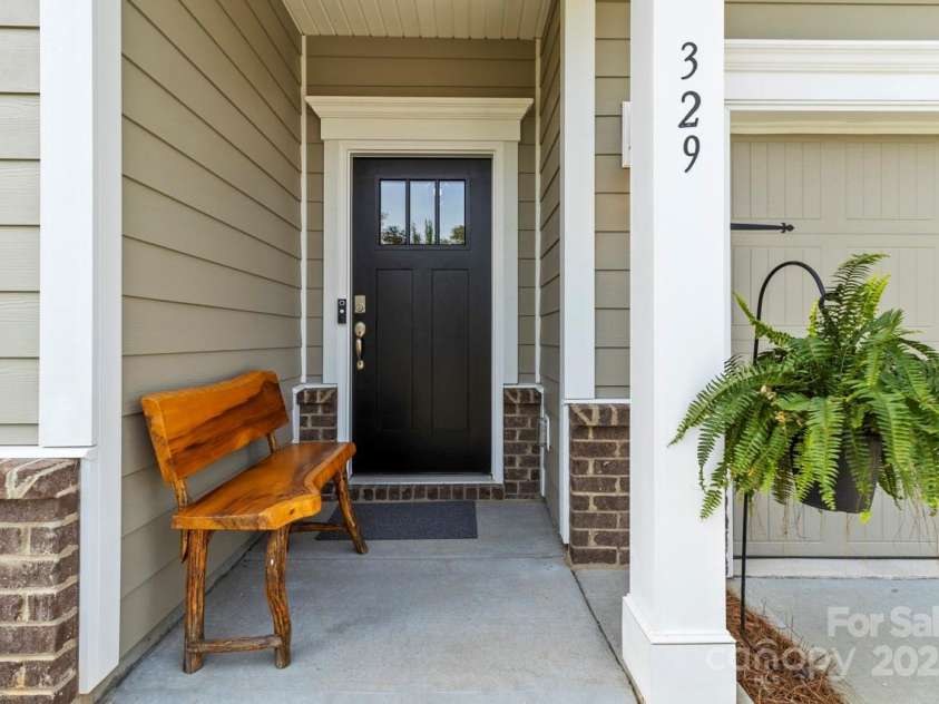 329 Secretariat Drive, Iron Station, NC 28080.  MLS# CAR4253728, YatesRealty ID 17822. Covered front entrance with room for a bench seat