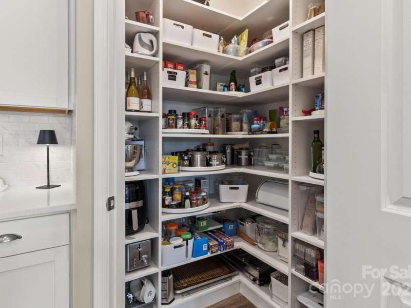 329 Secretariat Drive, Iron Station, NC 28080.  MLS# CAR4253728, YatesRealty ID 17822. Custom wood shelves keep the pantry organized