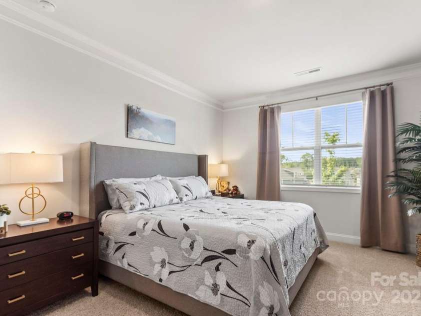 329 Secretariat Drive, Iron Station, NC 28080.  MLS# CAR4253728, YatesRealty ID 17822. The spacious primary bedroom features neutral carpeting