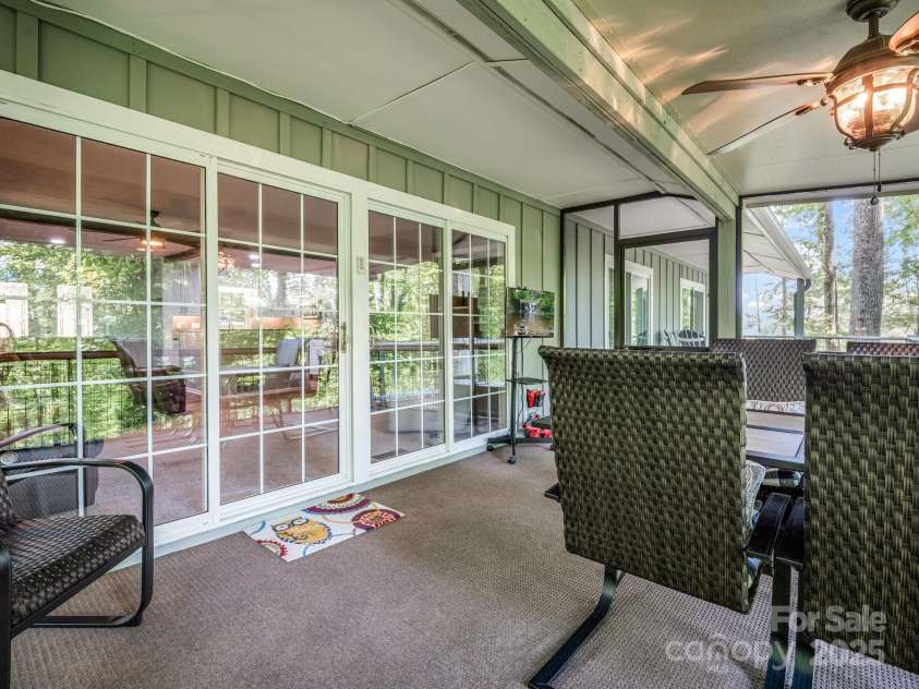 195 White Pine Drive, Lake Lure, NC 28746.  MLS# CAR4266532, YatesRealty ID 17828. Access the screened-in back deck from the open living space on the main level.