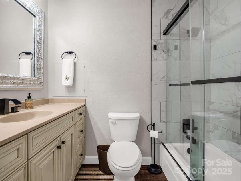 195 White Pine Drive, Lake Lure, NC 28746.  MLS# CAR4266532, YatesRealty ID 17828. Guest bath in the hallway between the main level living area and guest bedrooms.