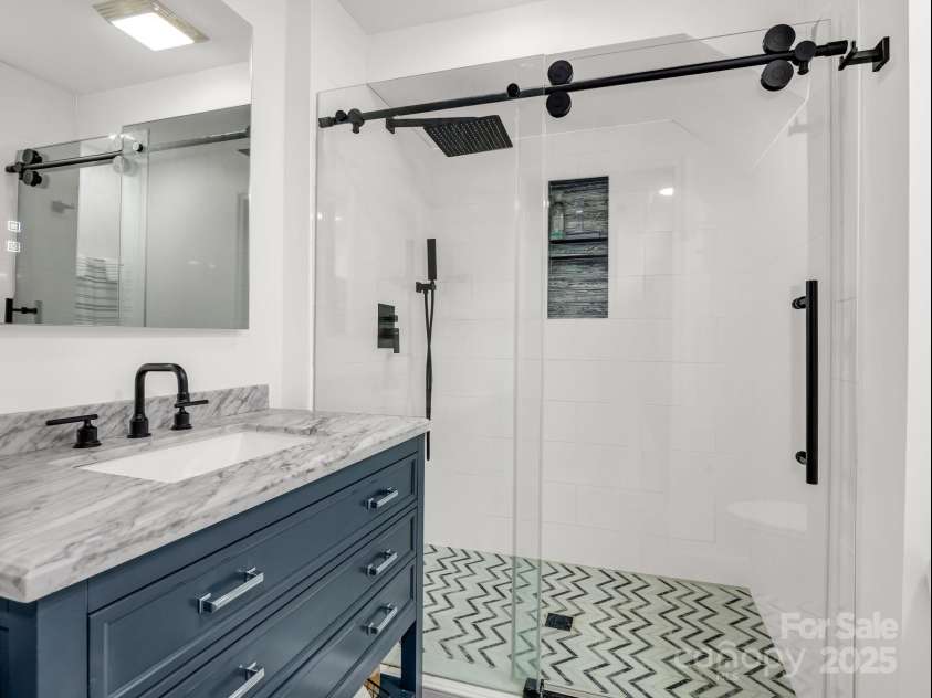 195 White Pine Drive, Lake Lure, NC 28746.  MLS# CAR4266532, YatesRealty ID 17828. Guest bath in the lower level between the guest room and family room.