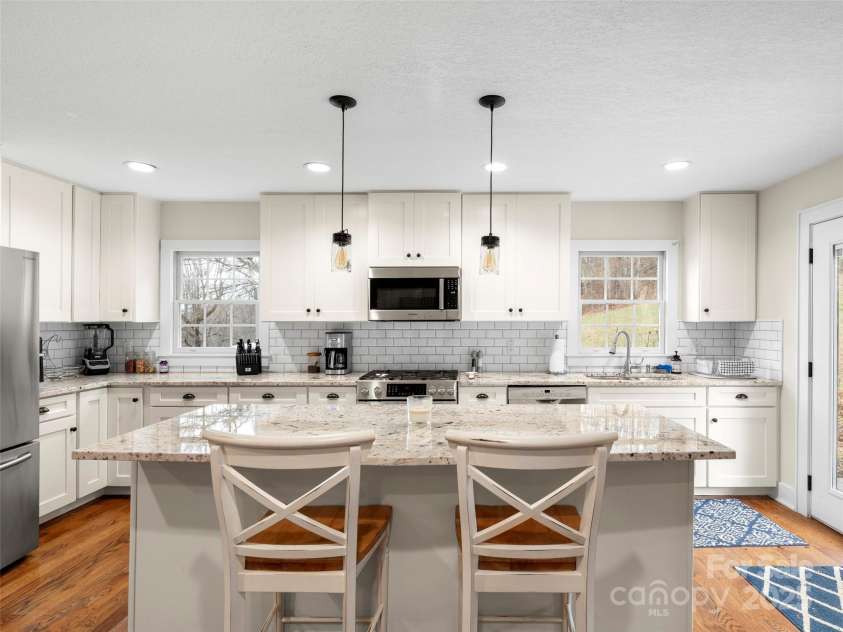 512 Shiloh Drive, Hendersonville, NC 28792.  MLS# CAR4208109, YatesRealty ID 17829. Kitchen island with overhang for seating and custom pendant lighting