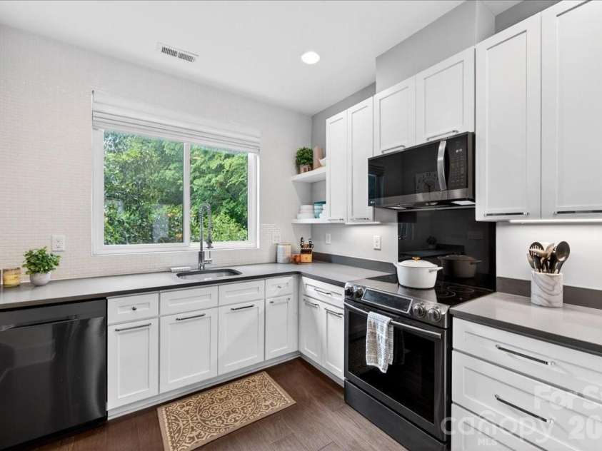 241 Domain Way, Charlotte, NC 28203.  MLS# CAR4374972, YatesRealty ID 17838. Kitchen with quartz countertops and black stainless appliances