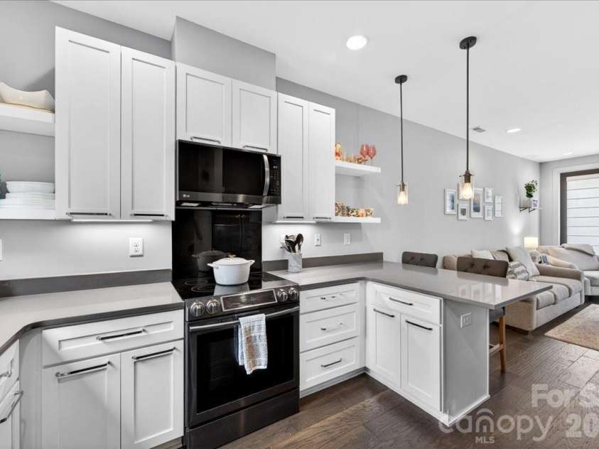 241 Domain Way, Charlotte, NC 28203.  MLS# CAR4374972, YatesRealty ID 17838. Kitchen with quartz countertops and black stainless appliances